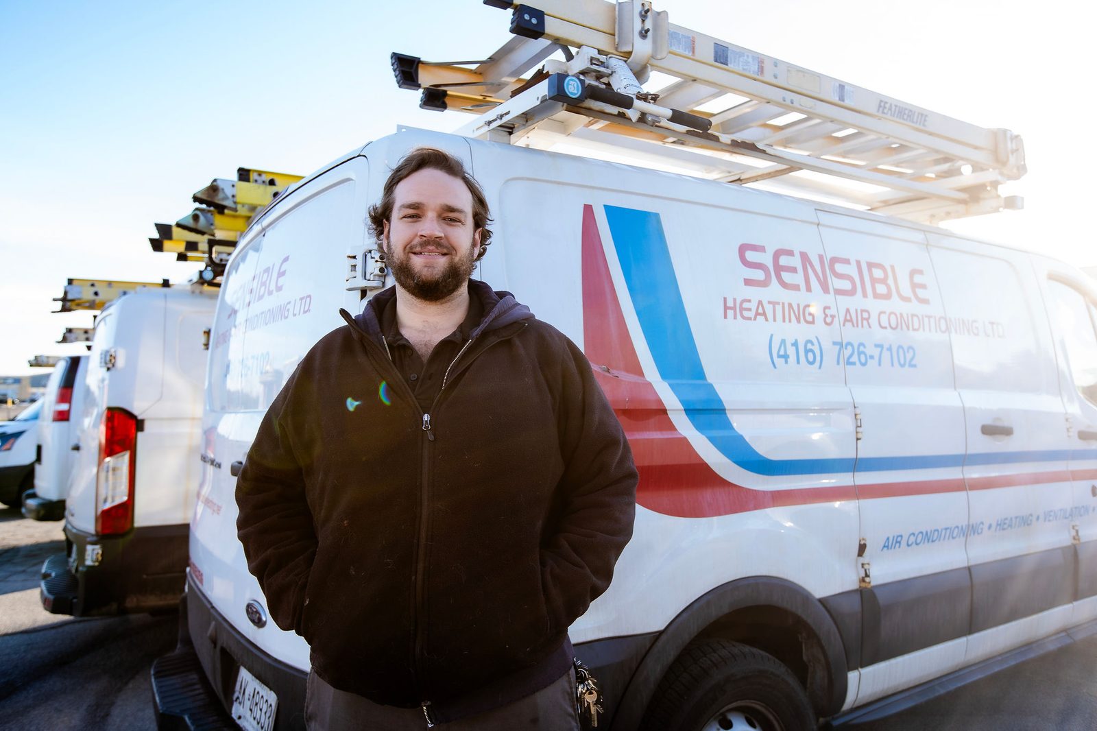 A Sensible technician in front of the branded service van A Sensible technician in front of the branded service van
