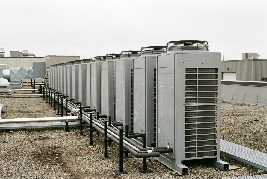 Commercial VRF condensing units connected by rooftop refrigerant piping